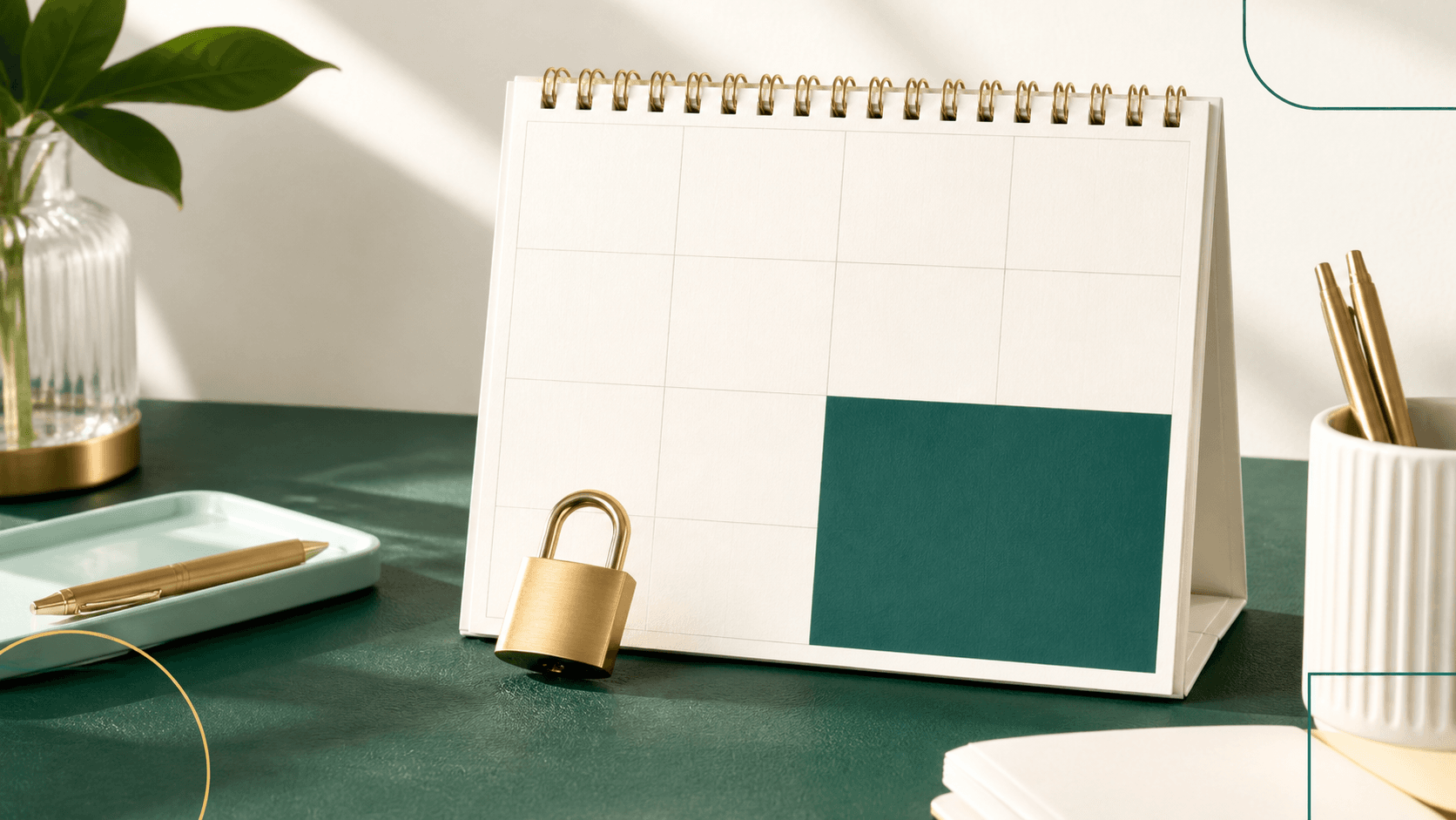 Brass padlock beside a blank calendar on a green desk