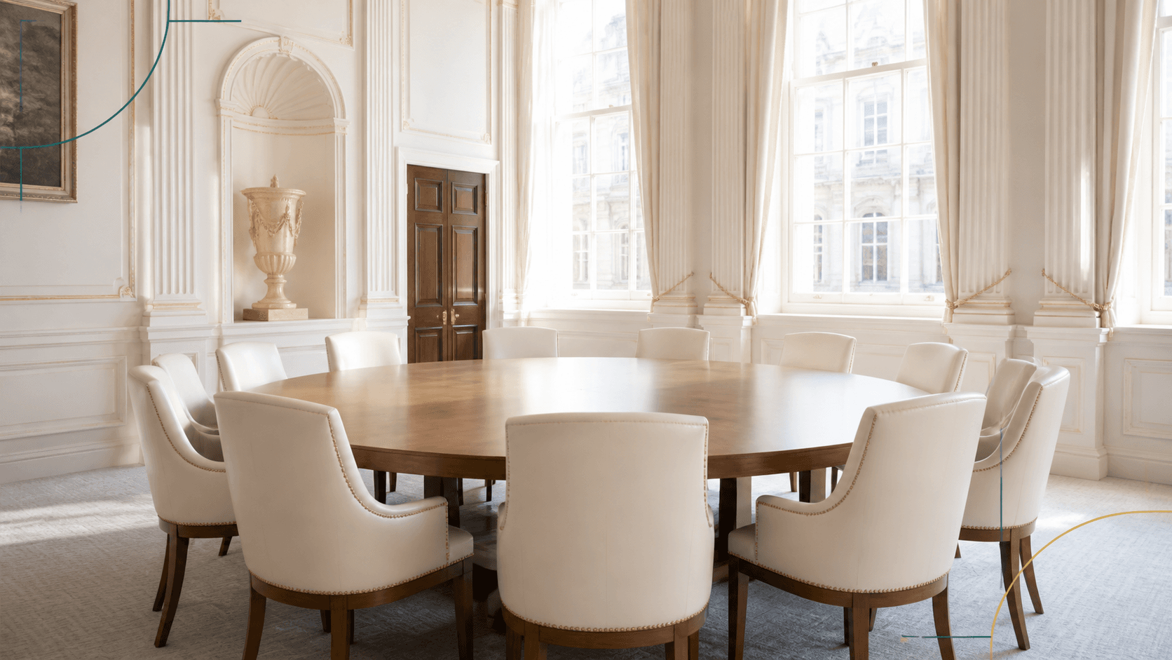 Empty round table and cream chairs in a bright historic London hall